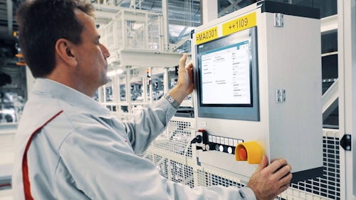An operator checking the display of production line